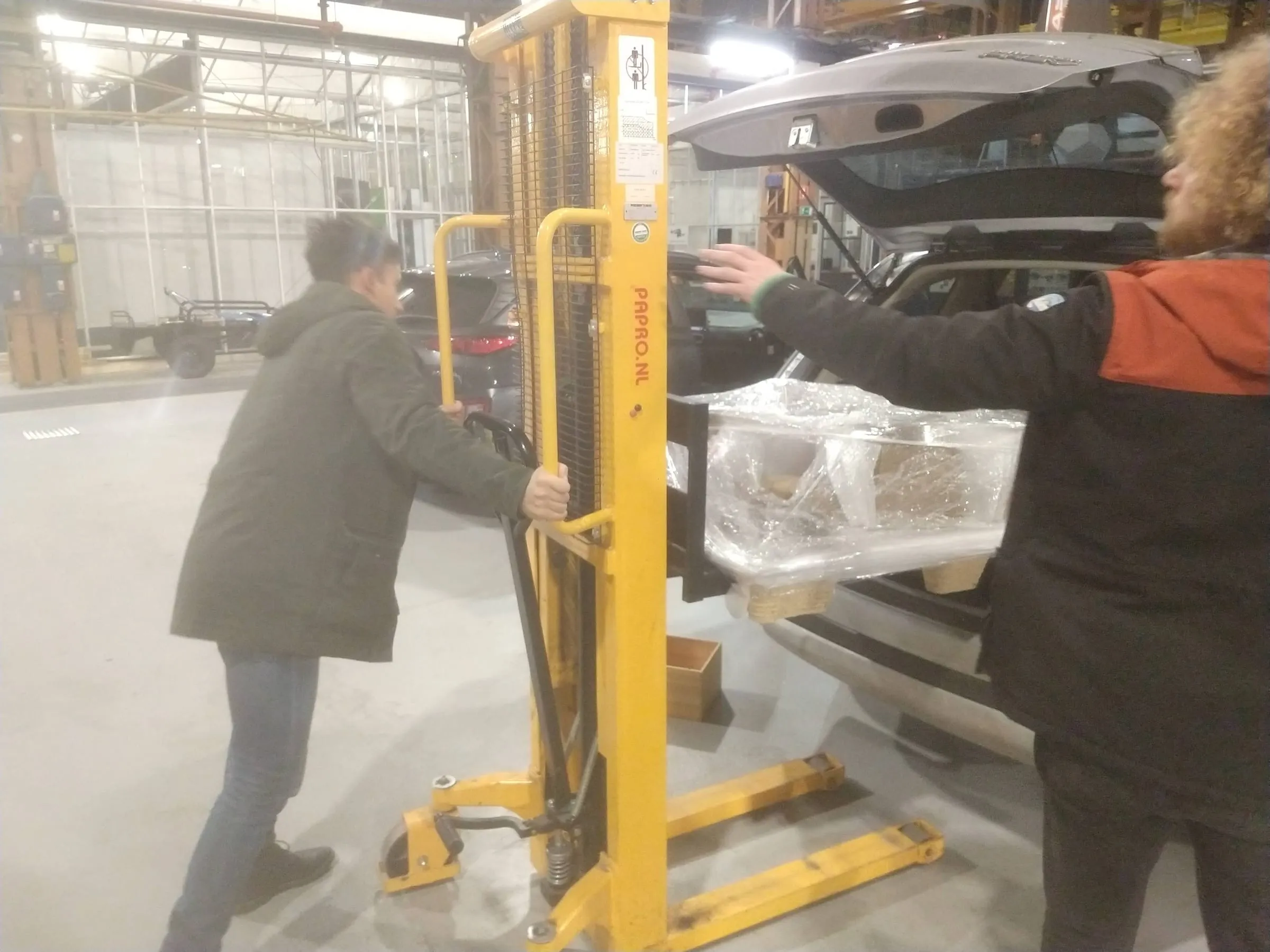 The crated sculpture being moved on a pallet truck