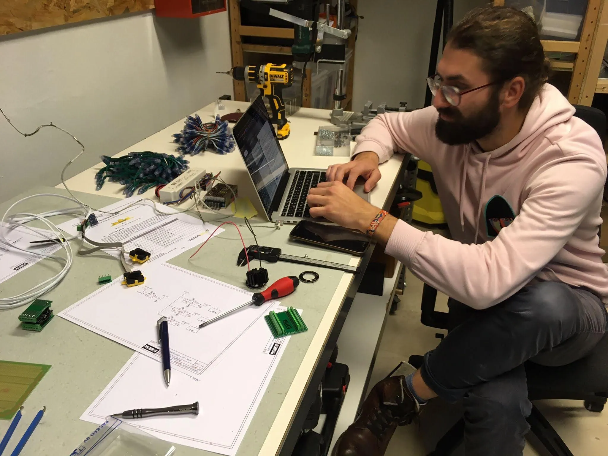 Bench work on the sensor and LED electronics, with schematics printed out