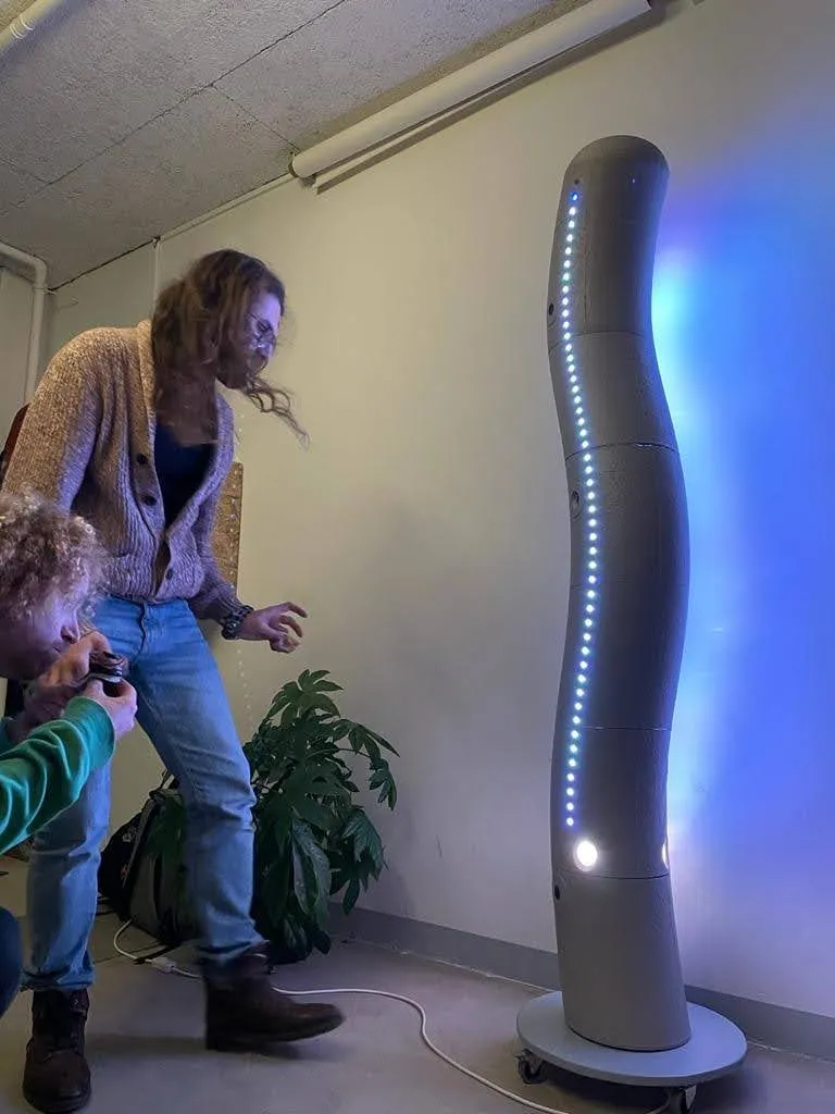 An early prototype of the sculpture being tested indoors, lit blue