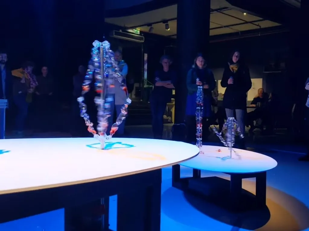 CHIME performing to an audience, its glass spiral curved under vibration
