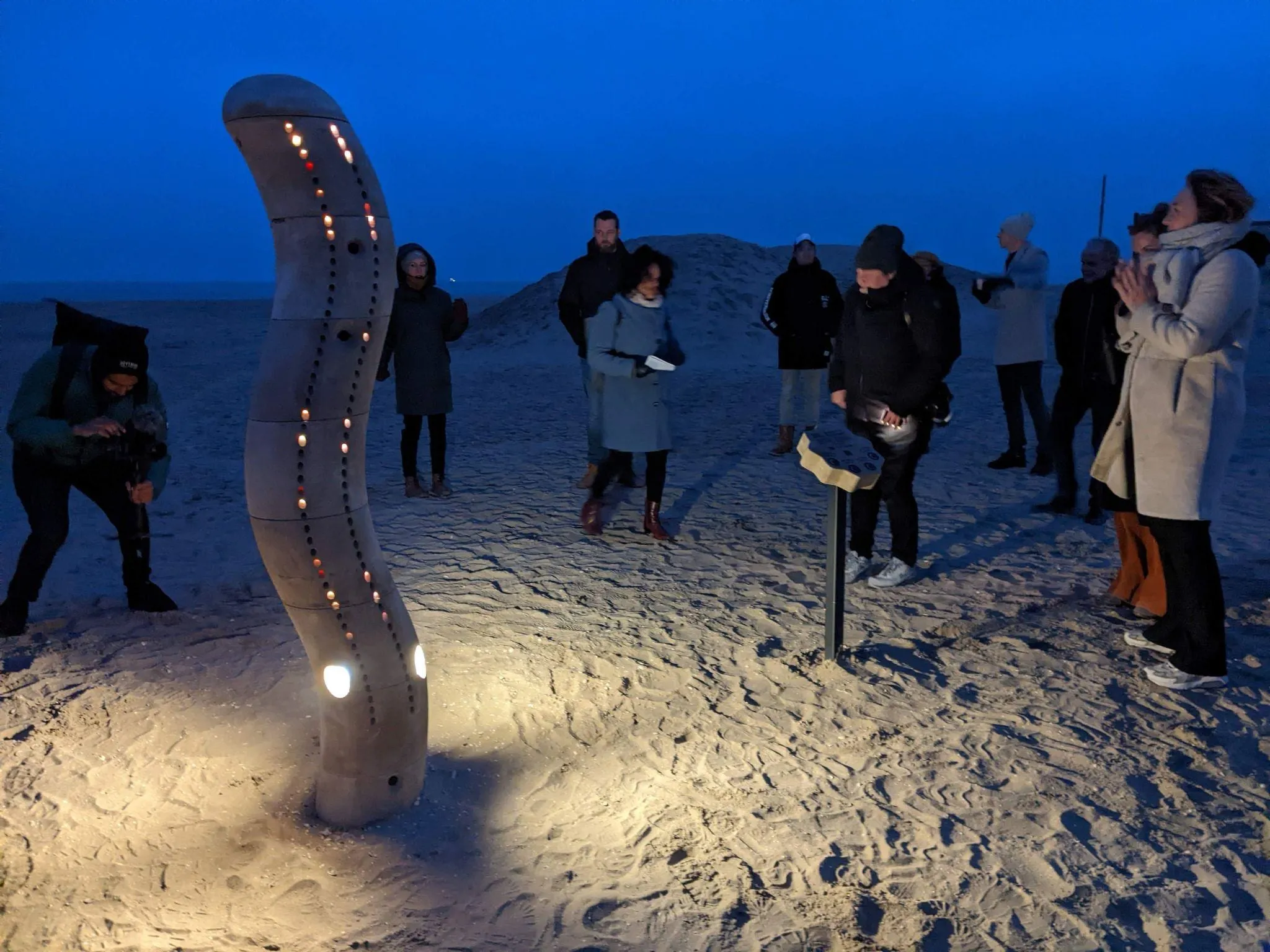 The Wave lit up at dusk on Scheveningen beach