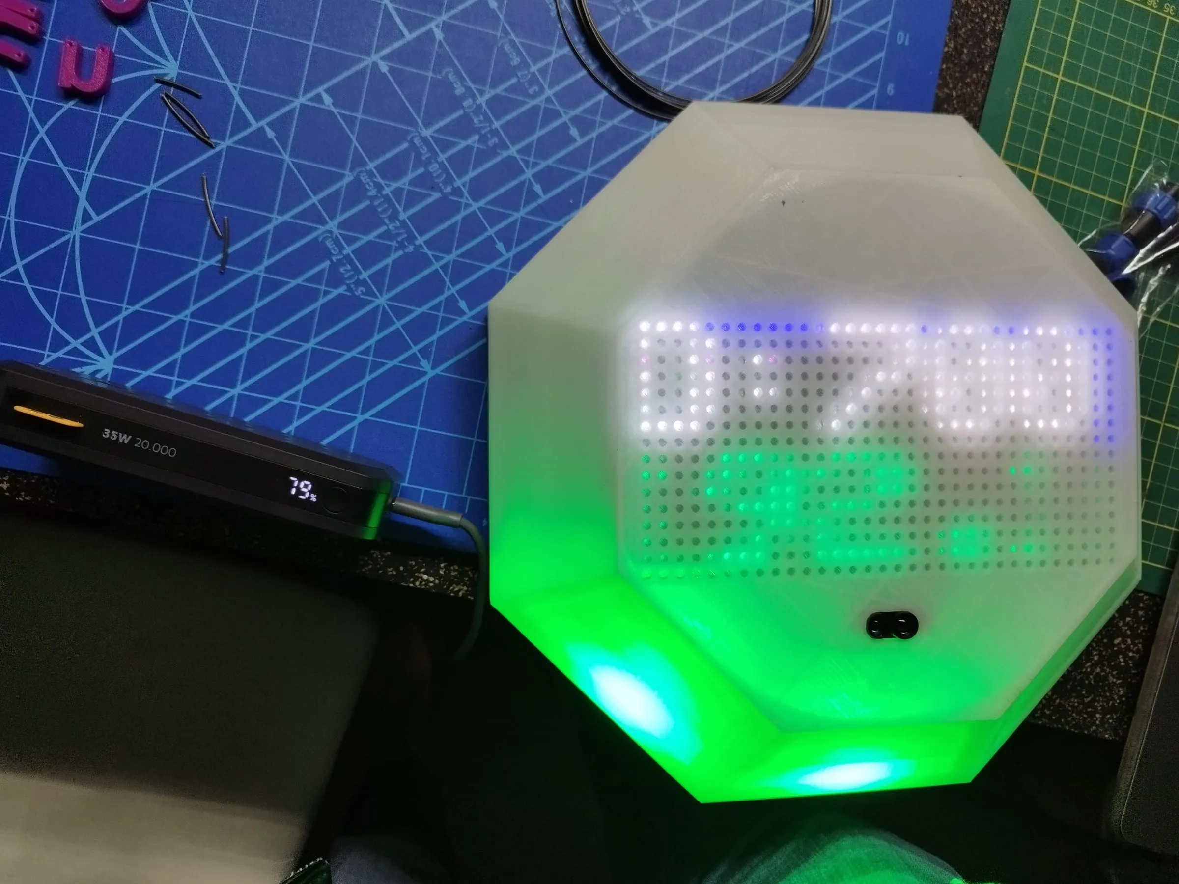 The LED matrix showing text through the diffuser on the bench