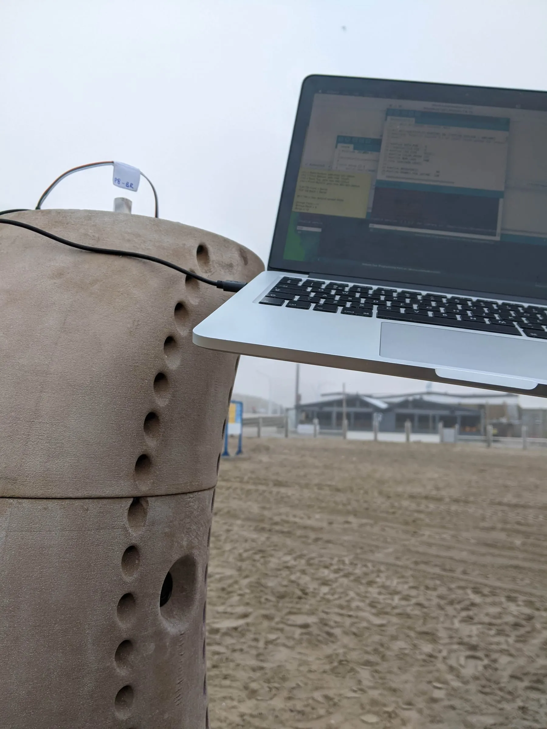 A laptop resting on the sculpture during on-site commissioning