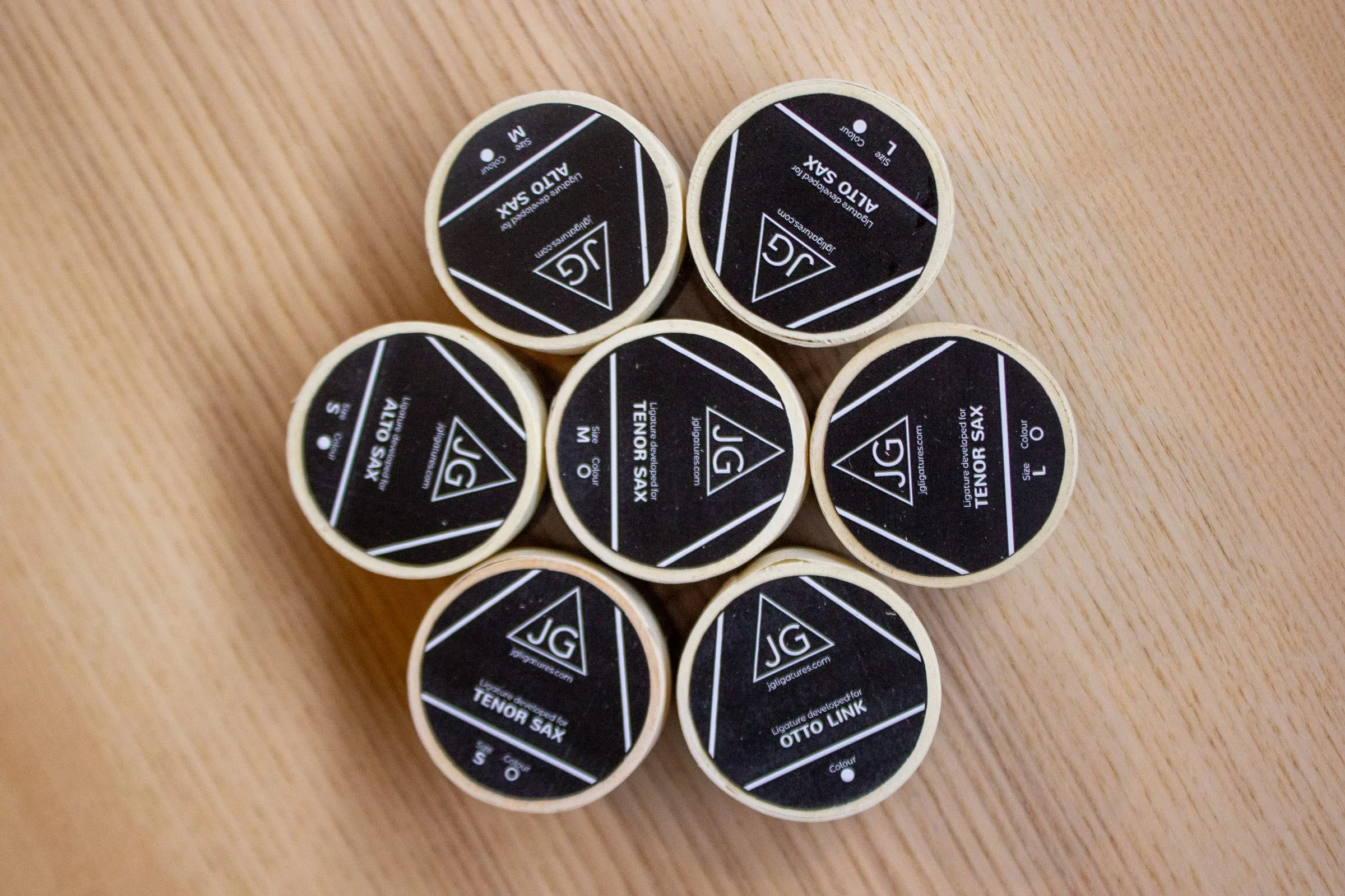 The JG Ligatures range in branded packaging, showing different models and fits